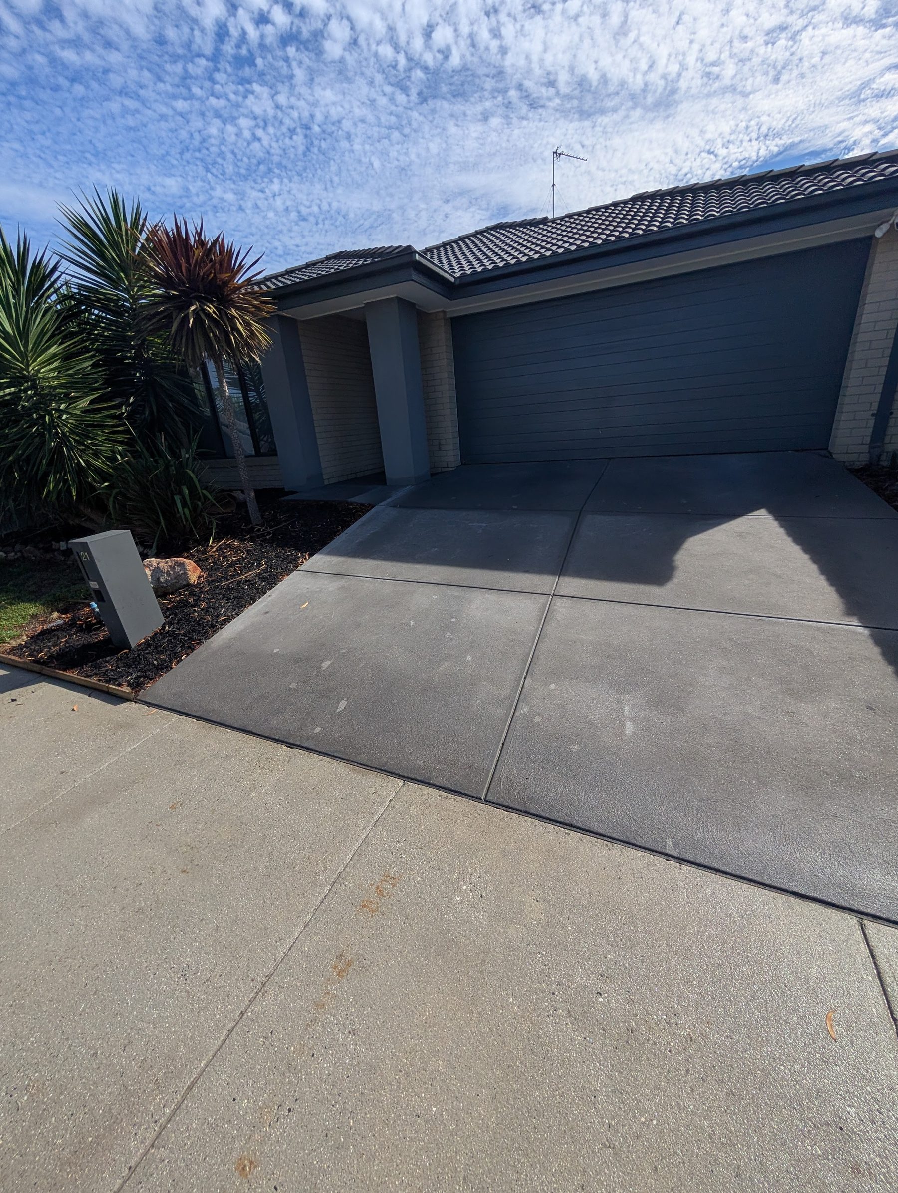 Driveway clean — patterned concrete — Stamped patterned concrete driveway pressure-washed evenly with a surface cleaner.