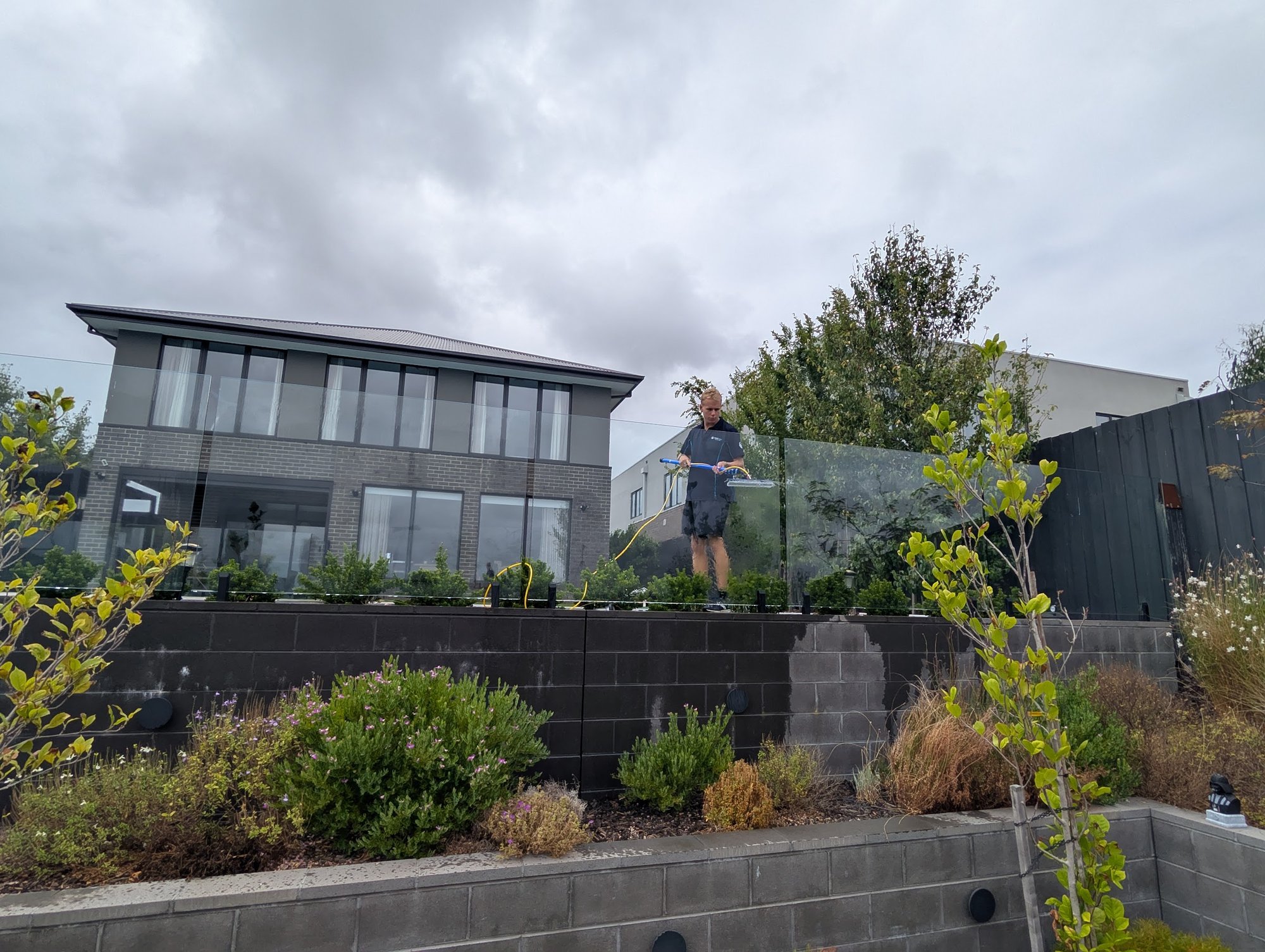 Renovation exterior wash — Two-storey contemporary home soft-washed top to bottom prior to handover.