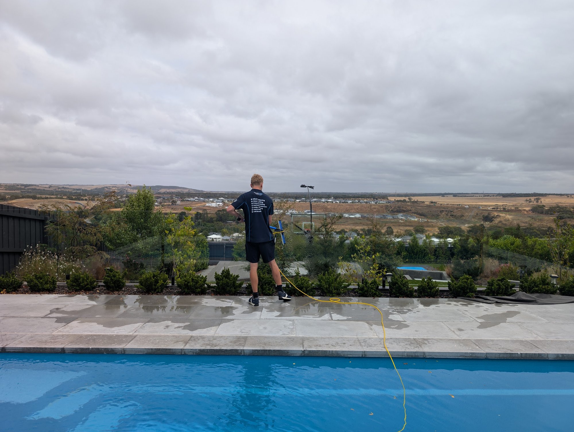 Soft-wash pool deck — coastal home — Salt-grime stripped off a coastal pool deck with a low-pressure soft wash — safe on pavers and grout.