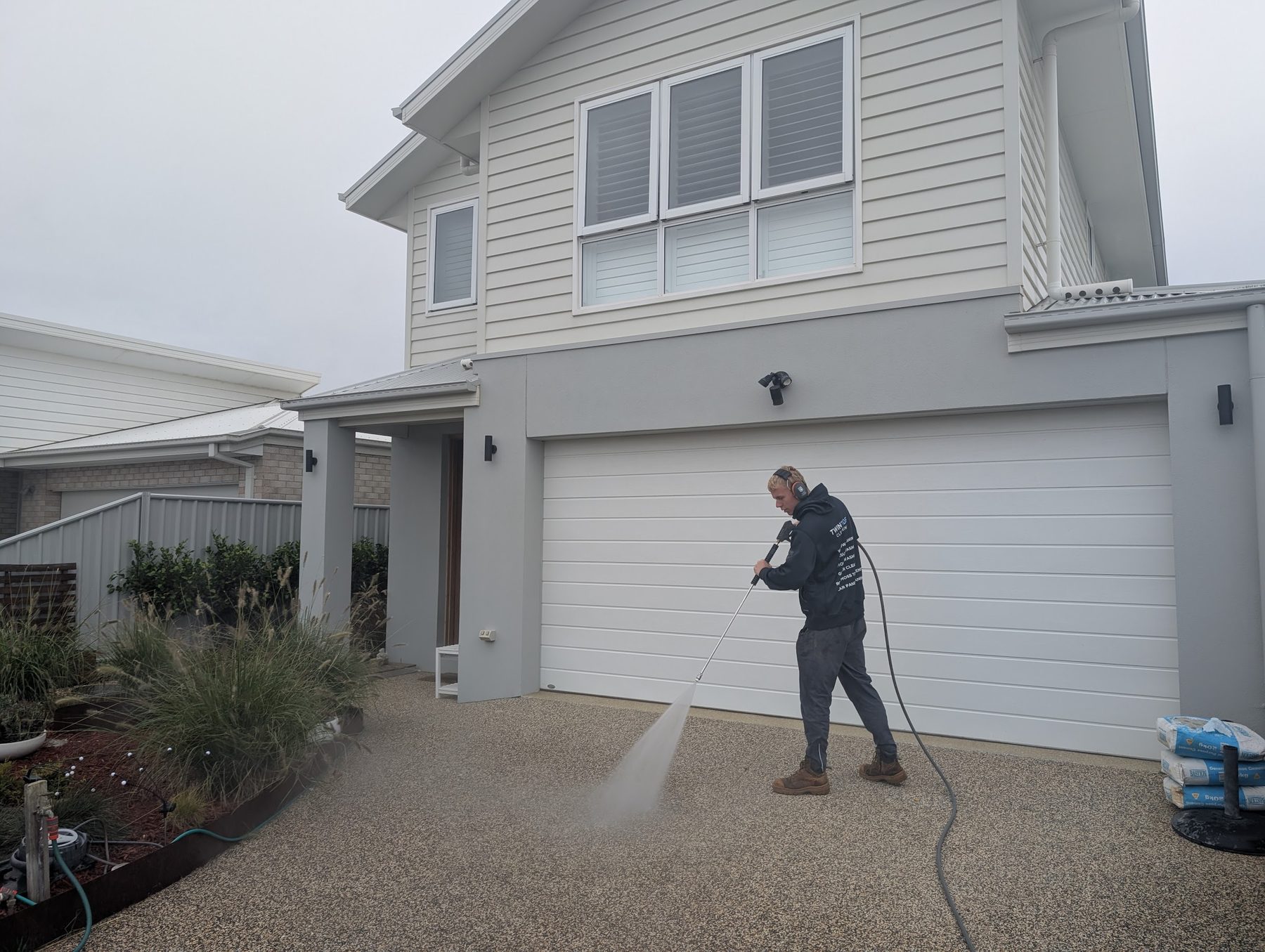 Driveway detail — bordered concrete — Edges and feature borders pressure-washed back to original colour on a Bellarine home.